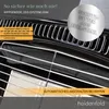 Close-up of a black gas heater with chrome grates and text overlays highlighting features. Produktbild-Vorschau