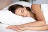A woman sleeps peacefully on a white pillow. Náhľad obrázku produktu