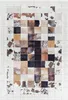 A flat lay of a rug with a patchwork design made of cowhide squares.