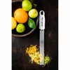 A grater with citrus zest and fruits. Anteprima dell’immagine prodotto