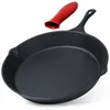A cast iron frying pan with a red silicone handle cover. Anteprima dell’immagine prodotto