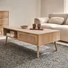 A living room scene with a coffee table, sofa, and chest of drawers. Produktbild-Vorschau