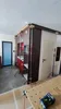 A kitchen under construction with cabinets being installed, supported by adjustable poles. Produktbild-Vorschau