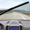 View from inside a car looking through the windshield on a rainy day, with the windshield wiper in motion. Anteprima dell’immagine prodotto