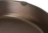 A close-up view of the rim and interior of a cast iron pan. Náhled obrázku produktu