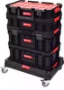 A stack of black toolboxes with red lids and accents, mounted on a black wheeled platform. Podgląd zdjęcia produktu