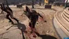 Two figures in a post-apocalyptic setting, one is hunched over with blood splattered around it, the other is running away. Produktbild-Vorschau