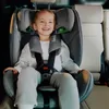 A young child is sitting in a car seat in the back seat of a car. Náhled obrázku produktu