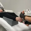 A person is receiving a pedicure treatment, with their foot elevated on a gray footrest. Náhled obrázku produktu