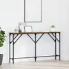A console table with decorative items on top, placed against a white wall. Náhled obrázku produktu