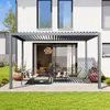 A modern pergola with a slatted roof is set up on a patio in front of a white house, furnished with outdoor seating and potted plants. Anteprima dell’immagine prodotto