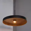 A close-up shot of a modern pendant light fixture with a black rim and a wood-grain interior. Produktbild-Vorschau