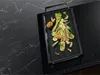 A grill pan filled with grilled vegetables sits on a black induction cooktop with a marble countertop. Podgląd zdjęcia produktu