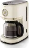 A cream-colored retro-style coffee maker with a glass carafe filled with coffee. Podgląd zdjęcia produktu
