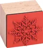 A close-up, studio shot of a snowflake-shaped rubber stamp mounted on a wooden block. Produktbild-Vorschau