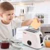A young boy is playing with a toy toaster in a kitchen setting. Anteprima dell’immagine prodotto