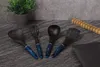 A set of kitchen utensils arranged on a textured surface with a potted plant in the background. Podgląd zdjęcia produktu