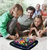 A family playing a board game with colorful marbles on the floor. Produktbild-Vorschau