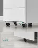 Close-up of the bottom of a white cabinet with wheels and a diagram illustrating the wheel locking mechanism. Anteprima dell’immagine prodotto