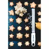 Star-shaped cookies arranged on a dark surface with a grater and a lemon. Anteprima dell’immagine prodotto