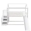 A white wooden house-shaped bunk bed with a slide and stairs. Anteprima dell’immagine prodotto