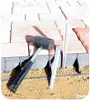 A rubber mallet and stakes are shown next to a border of pavers and landscaping edging, suggesting installation or repair. Produktbild-Vorschau