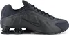 A black Nike Shox R4 sneaker is shown from the side against a white background. Produktbild-Vorschau