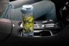 A portable blender filled with ingredients is placed in the cup holder of a car's center console. Podgląd zdjęcia produktu