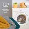 A washing machine with folded blankets in front, and a plant and basket on top. Náhľad obrázku produktu