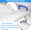 A close-up view of a white bathtub seat with a blue handle and a small bar of soap on it. The image also includes a smaller inset showing a hand gripping the blue handle. Náhled obrázku produktu