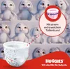 A marketing image for Huggies baby diapers featuring animated bunnies and a close-up of a diaper. Produktbild-Vorschau
