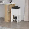 A white nightstand with a wooden accent is placed next to a desk. The nightstand has two shelves and a cabinet. A gaming console and controllers are placed on top and on the lower shelf. Produktbild-Vorschau