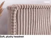 A close-up view of a plush headrest with a textured, ribbed fabric in a beige color. Produktbild-Vorschau