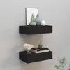 Two black floating shelves mounted on a light gray wall, decorated with various items. Náhled obrázku produktu