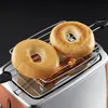 Two bagels are being toasted on a rack inside a toaster. Produktbild-Vorschau