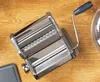 A pasta maker is placed on a wooden surface. Anteprima dell’immagine prodotto