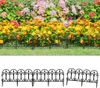 A black metal garden border fence in front of a flower bed. Produktbild-Vorschau