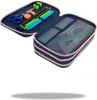 A blue pencil case with pink trim is open, showing its contents. The left side contains scissors, an eraser, a sharpener, and pencils. The right side contains rulers and protractors in a clear plastic compartment. Náhled obrázku produktu