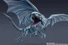 A close-up, dynamic shot of a Blue-Eyes White Dragon action figure in mid-flight. Produktbild-Vorschau