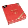 A stack of red paper napkins with a gold embossed pattern and text on the packaging. Voir les images du produit