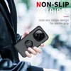 A person is holding a black phone case with a ring holder attached. The background is blurred and appears to be outdoors. Produktbild-Vorschau