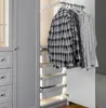 A closet with clothes hanging on a rack and storage baskets inside. Produktbild-Vorschau