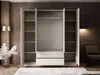 An open wardrobe with shelves and drawers, set in a bedroom with a chair and lamp. Náhled obrázku produktu