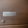 A close-up of a metallic plaque with the brand name 'hiyard' embossed on it, attached to a textured brown surface. Podgląd zdjęcia produktu