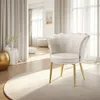 A white velvet armchair with gold legs sits on a round rug in a well-lit room with sheer curtains. Produktbild-Vorschau