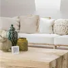 A digital thermometer and hygrometer sits on a wooden coffee table in front of a white couch with decorative pillows and vases. Anteprima dell’immagine prodotto