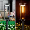 A split image showing a solar garden light in daylight and at night. Anteprima dell’immagine prodotto