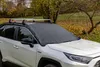 A white car with a black windshield cover parked outdoors. Náhled obrázku produktu