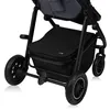 Close-up view of the lower part of a stroller, focusing on the wheels and storage basket. Produktbild-Vorschau