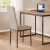 A modern dining chair next to a desk with a laptop. Produktbild-Vorschau